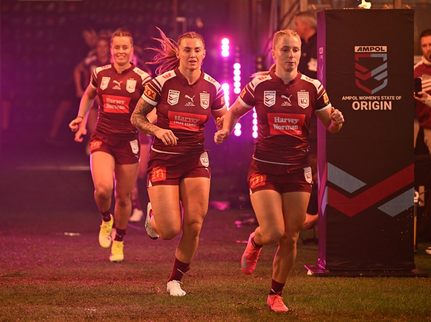Tarryn Aiken runs out for Queensland with Julia Robinson and Lauren Brown.