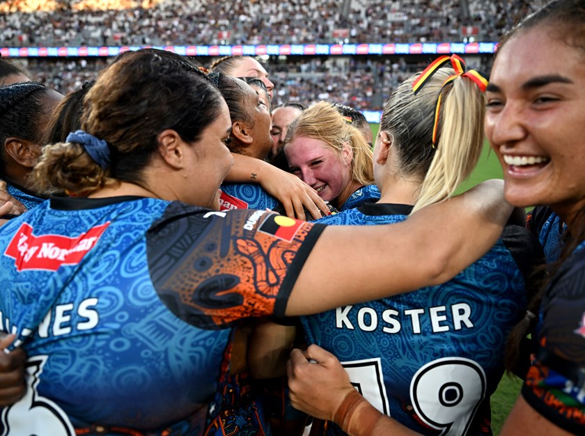 Indigenous All Stars rookies Lailani Montgomery (centre) and Ella Koster celebrate with team-mates after their 20-18 defeat of the Māori Ferns.