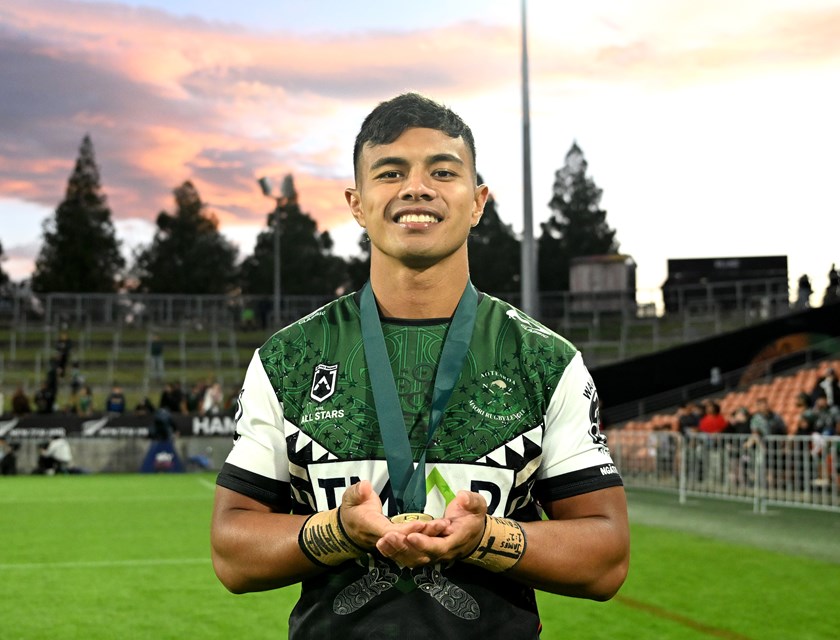 Keano Kini proudly displays his player of the match medal.