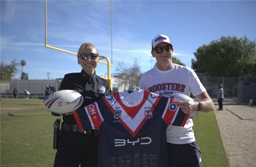 Sydney Roosters CEO Joe Kelly presented a Roosters jersey to LAPD Deputy Chief Ruby Flores.